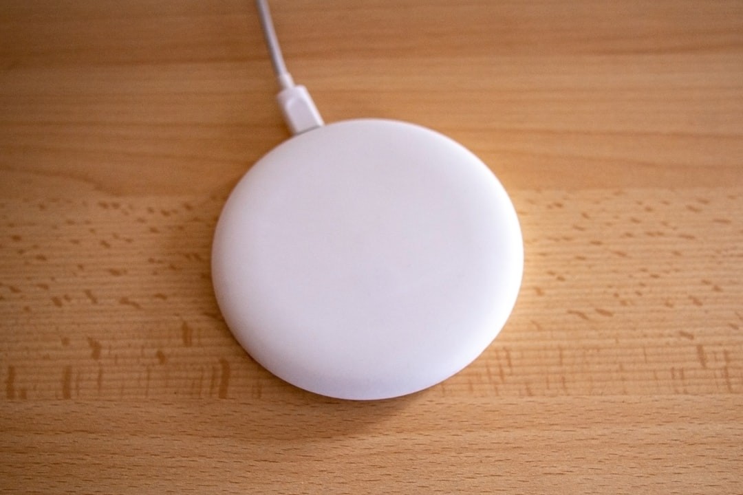 white round device on brown wooden table